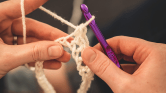 Two hands crocheting