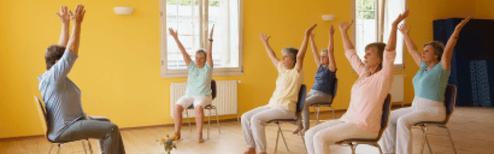 Women sitting in chairs and stretching